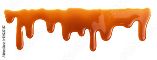 Dripping caramel drops of sweet sauce isolated on white background. Melted caramel sauce photo