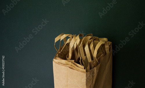 Paper shopping bags. Storage and use of bags. Packing. Dark background. Minimalism
