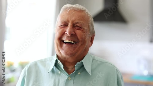 Happy senior man laughing in his home

