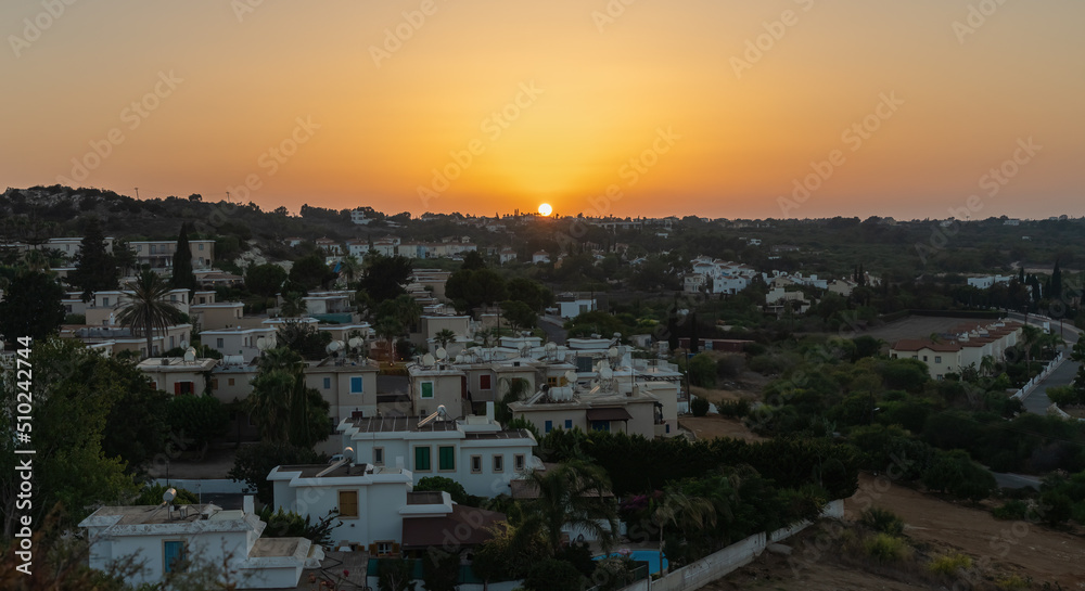 Sunset over the roofs of houses in Protaras, Cyprus