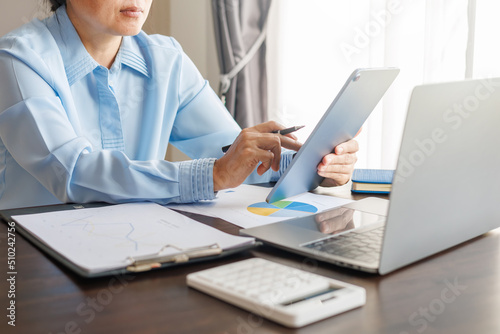 Business woman analyzing graph, Business team meeting and financial graph data analysis and is having an online meeting about business, business concept.