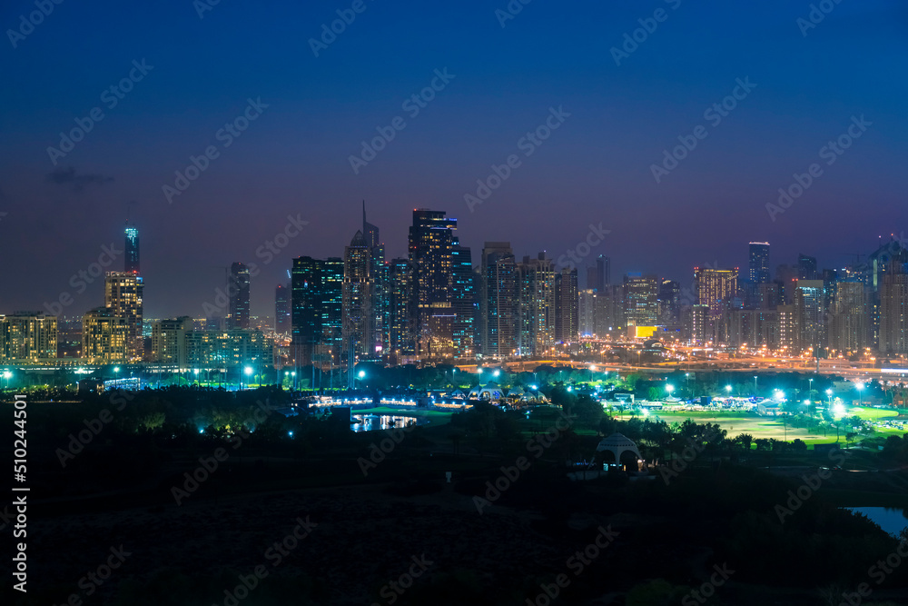 View of the skyline by Dubai Marina, Jumeirah lake towers and the Media City with golf field in the foreground