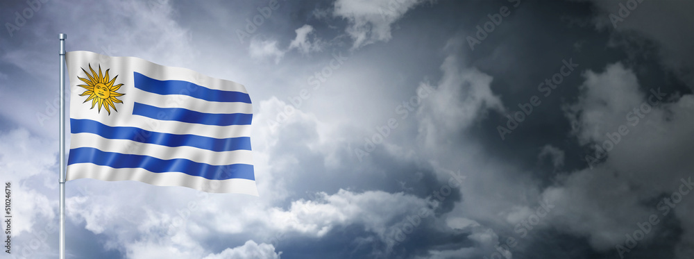 Obraz premium Uruguaian flag on a cloudy sky