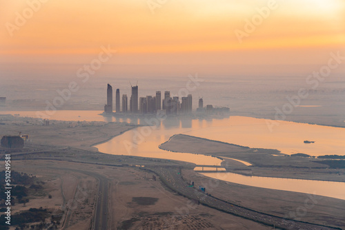Skyline of towers by the Dubai Creek harbor by sunrise in winter