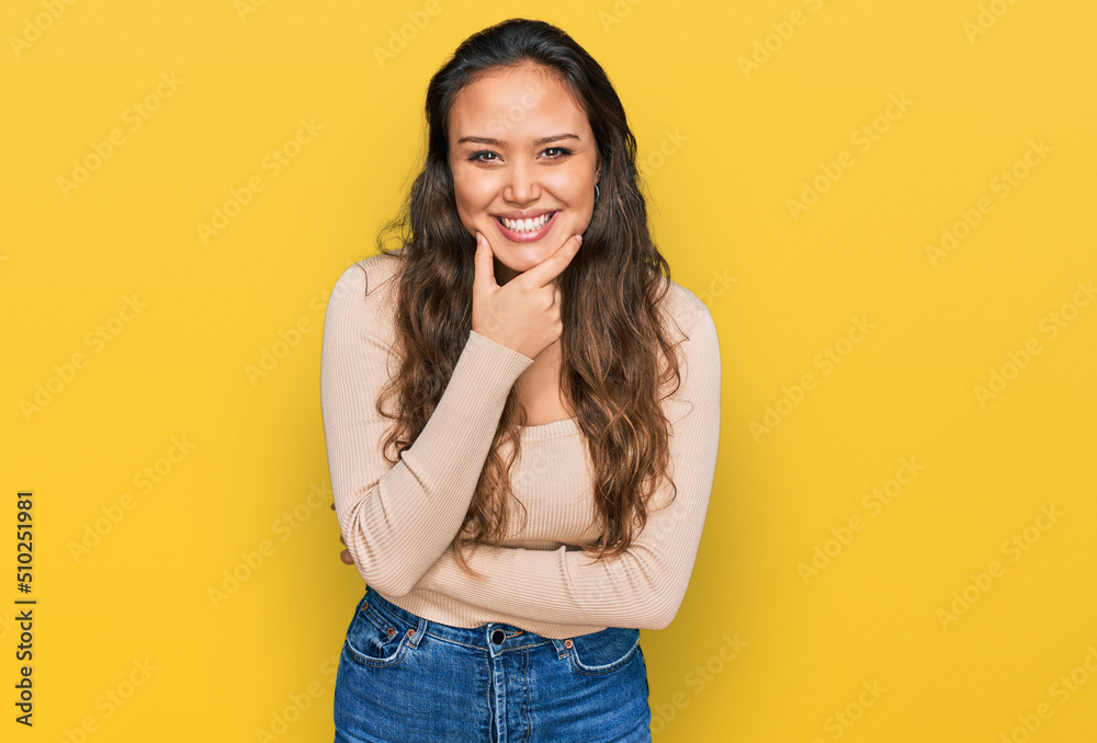 Young hispanic girl wearing casual clothes looking confident at the camera smiling with crossed arms and hand raised on chin. thinking positive. Young hispanic girl wearing casual clothes looking confident at the camera smiling with crossed arms and hand raised on chin. thinking positive.
