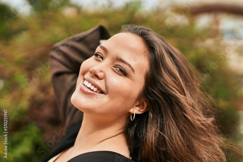 Young hispanic woman smiling happy standing at the city.