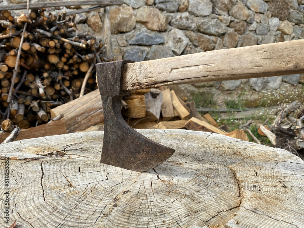 Axe stuck in tree stump. Preparing for winter concept. Firewood. Axe stuck in tree stump. Preparing for winter concept. Firewood.