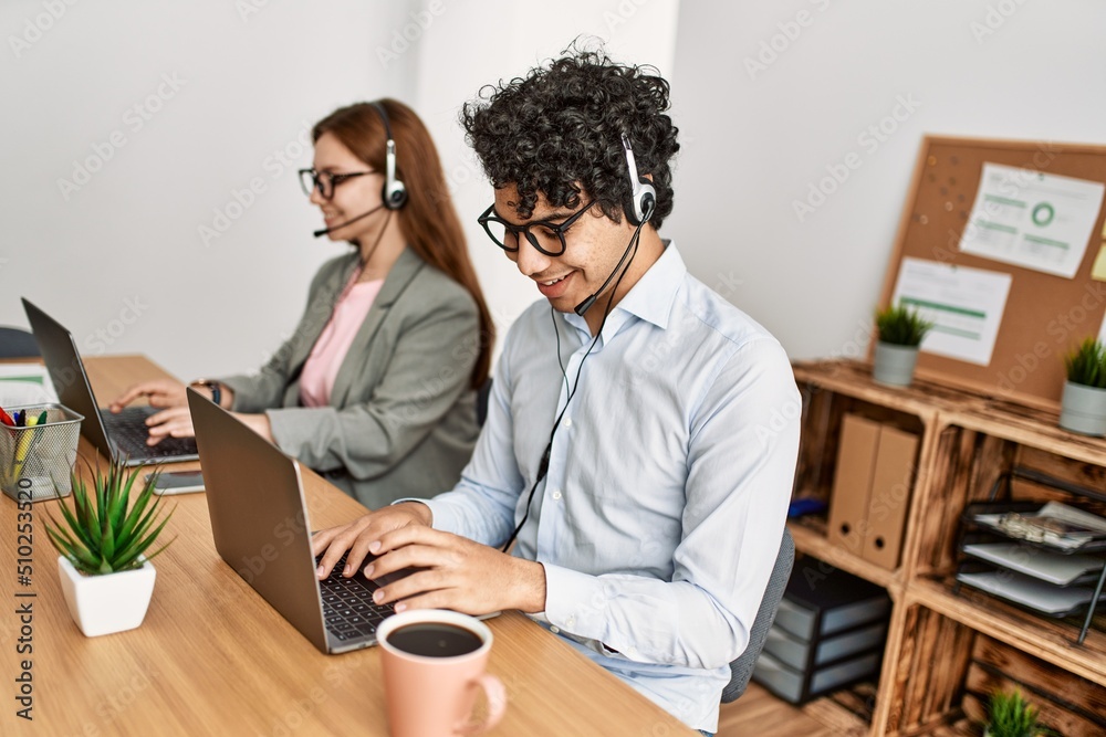Two call center agent smiling happy working at the office. Two call center agent smiling happy working at the office.