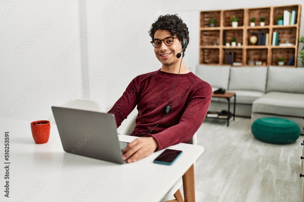 Young hispanic call center agent man working at home. Young hispanic call center agent man working at home.