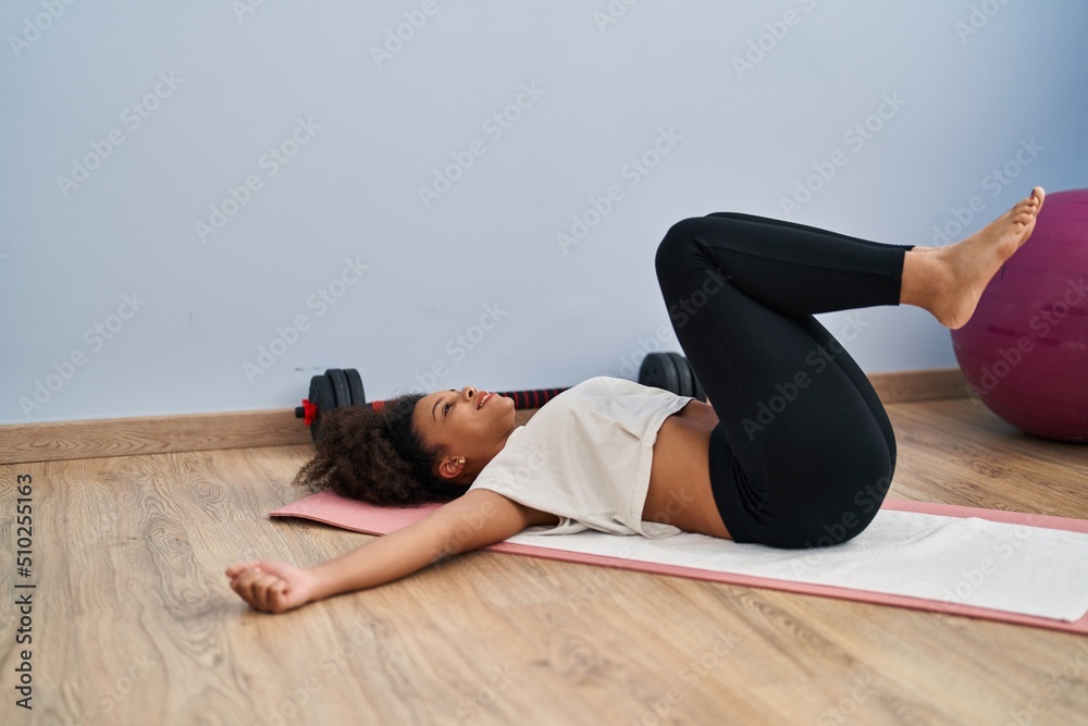 Young african american woman smiling confident training abs exercise at sport center Young african american woman smiling confident training abs exercise at sport center
