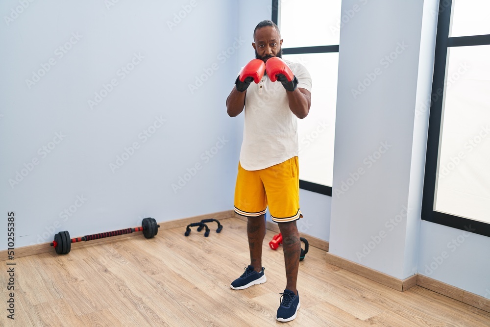 Young african american man with serious expression boxing at sport center Young african american man with serious expression boxing at sport center