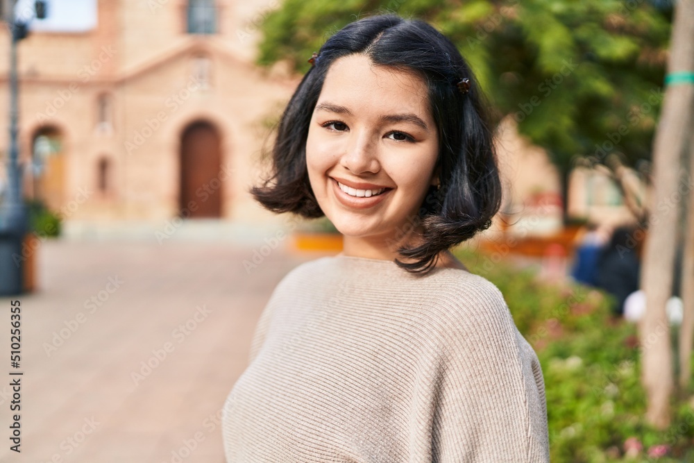Young woman smiling confident looking to the camera at park