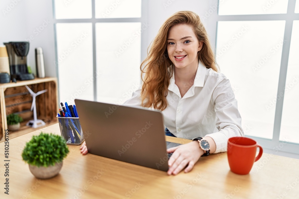 Young caucasian woman working at the office using computer laptop with a happy and cool smile on face. lucky person. Young caucasian woman working at the office using computer laptop with a happy and cool smile on face. lucky person.