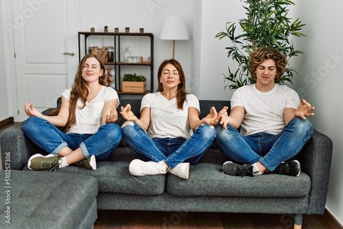 Mother and couple smiling confident doing yoga exercise at home