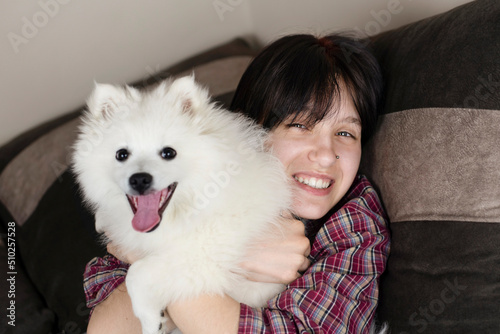 Fototapeta Naklejka Na Ścianę i Meble -  Teen girl hugging her anti depressant, her dog and girl happy and smiling, her doggy helped to overcome depression and believe in herself. Happy girl and her dog friend