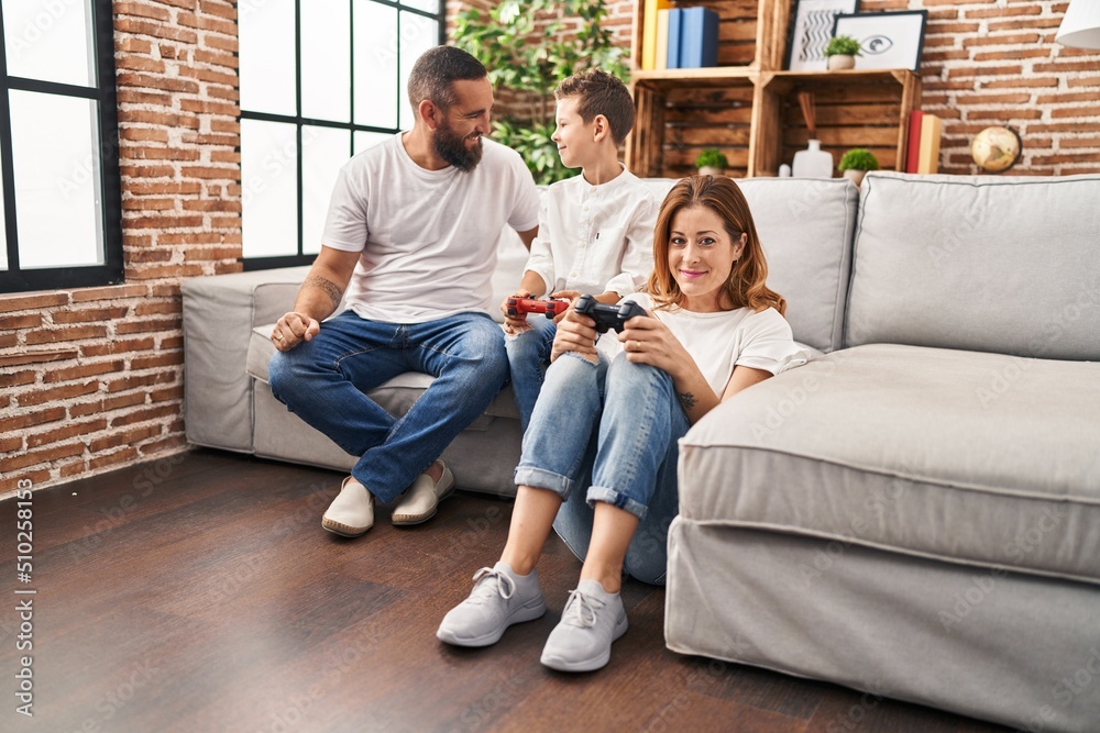 Family smiling confident playing video game at home Family smiling confident playing video game at home