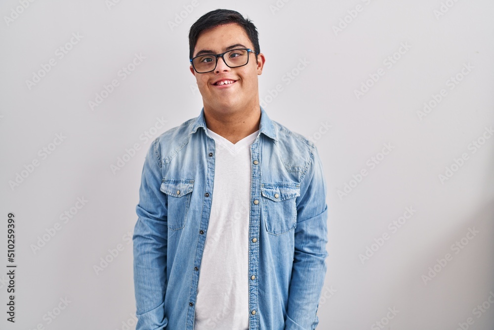 Young hispanic man with down syndrome wearing casual denim jacket over white background with a happy and cool smile on face. lucky person. Young hispanic man with down syndrome wearing casual denim jacket over white background with a happy and cool smile on face. lucky person.