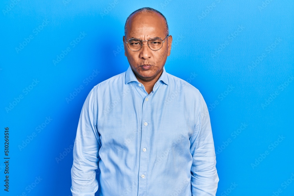 Middle age latin man wearing casual clothes and glasses depressed and worry for distress, crying angry and afraid. sad expression. Middle age latin man wearing casual clothes and glasses depressed and worry for distress, crying angry and afraid. sad expression.