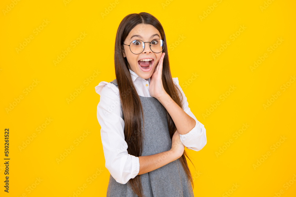 Shocked teenager child with amazed look on yellow background, amazement. Excited face. Amazed expression, cheerful and glad.