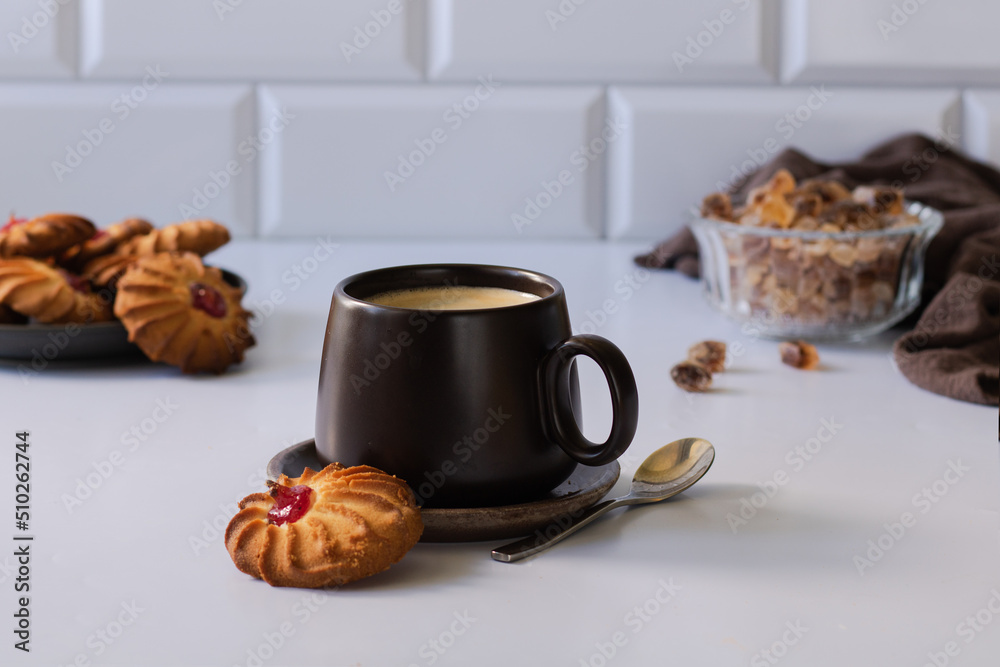 Cup of coffee with cookies, cookies in the background, and caramelized sugar. Cup of coffee with cookies, cookies in the background, and caramelized sugar.
