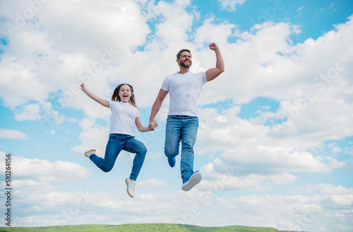 happy father and daughter jump in sky. family support