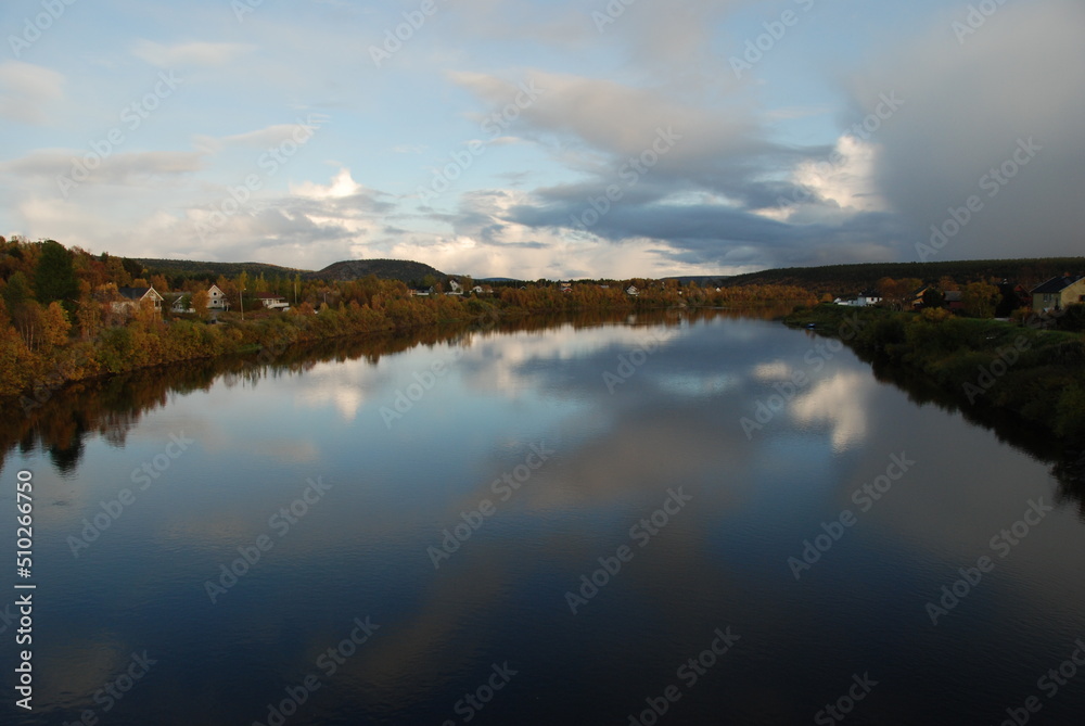 Karasjok village and its autumn surroundings reflected in Karasjohka River, Finnmark region, Norway