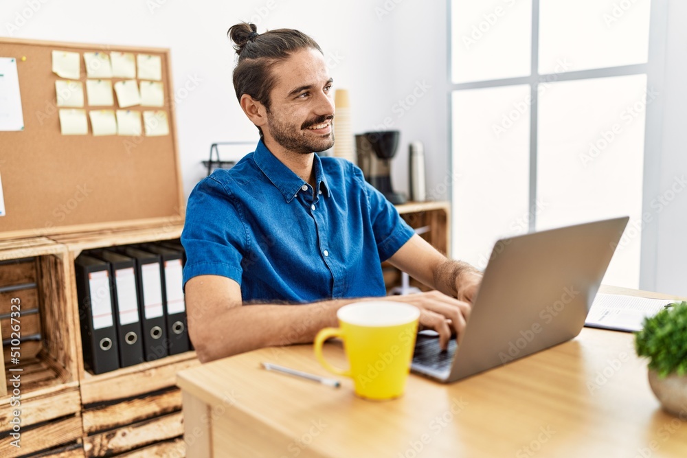 Handsome hispanic man working with laptop at the office Handsome hispanic man working with laptop at the office