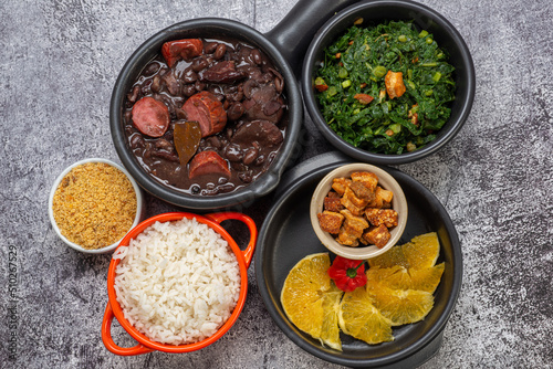 FEIJOADA: typical and traditional food of Brazilian cuisine, served with rice, farofa, orange, pepper and cabbage
