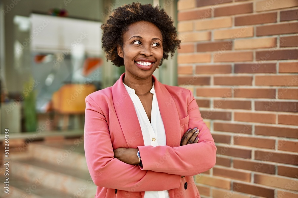 Beautiful business african american woman with afro hair smiling happy and confident outdoors at the city Beautiful business african american woman with afro hair smiling happy and confident outdoors at the city