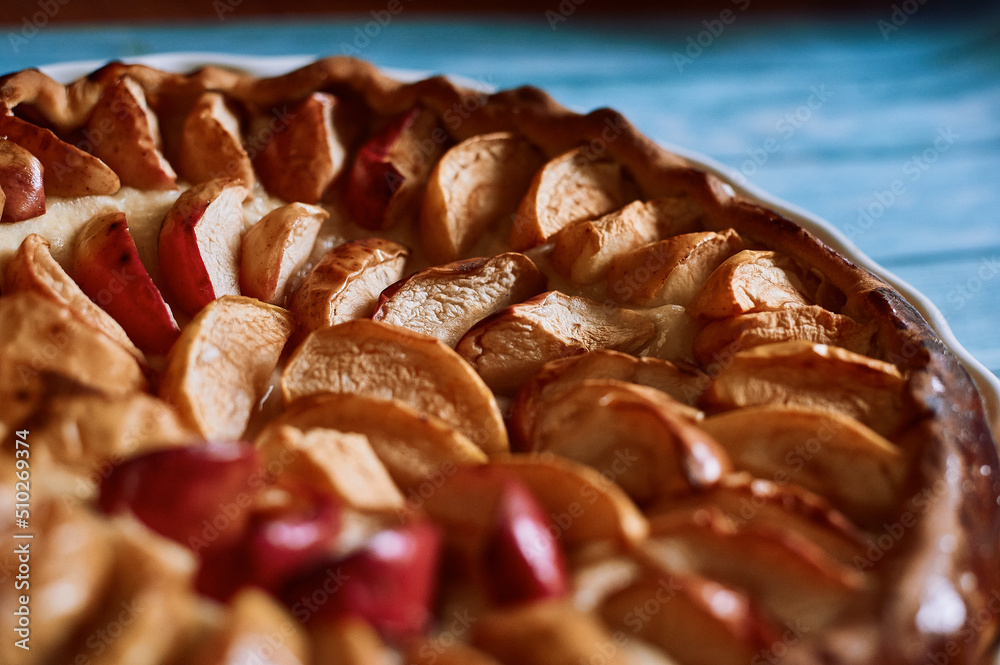 apple pie fresh pastries with apples red apples on a blue background white dishes apple pie fresh pastries with apples red apples on a blue background white dishes