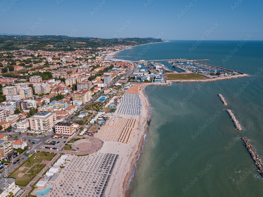 Italy, June 2022; aerial view of Fano with its sea, beaches, port, umbrellas in the marche region Italy, June 2022; aerial view of Fano with its sea, beaches, port, umbrellas in the marche region