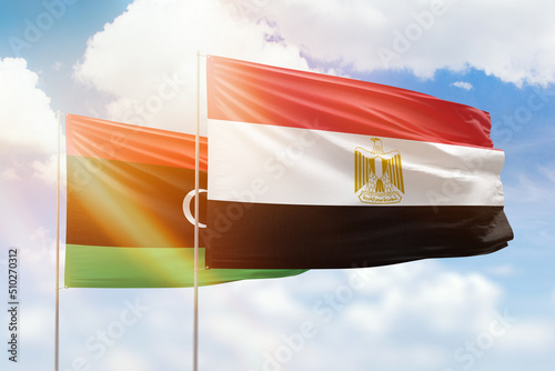 Sunny blue sky and flags of egypt and libya photo