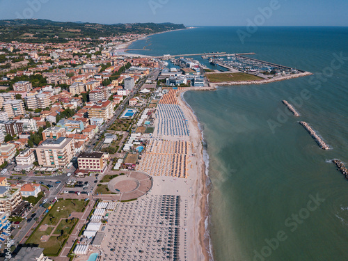 Italy, June 2022; aerial view of Fano with its sea, beaches, port, umbrellas in the marche region