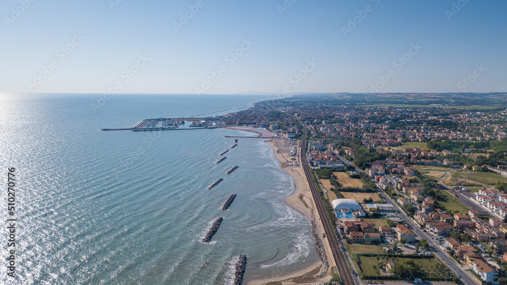 Italy, June 2022; aerial view of Fano with its sea, beaches, port, umbrellas