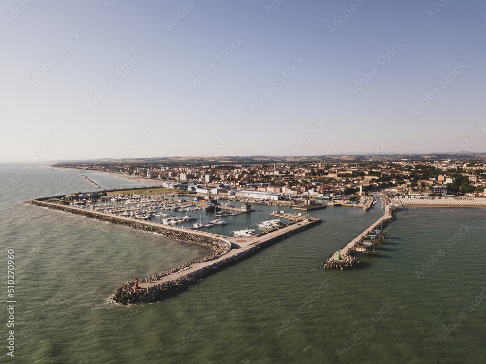 Italy, June 2022; aerial view of Fano with its sea, beaches, port, umbrellas Italy, June 2022; aerial view of Fano with its sea, beaches, port, umbrellas