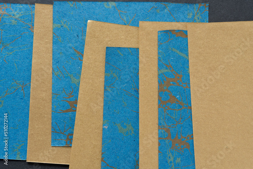blue paper with pattern interleaved with gold paper photo
