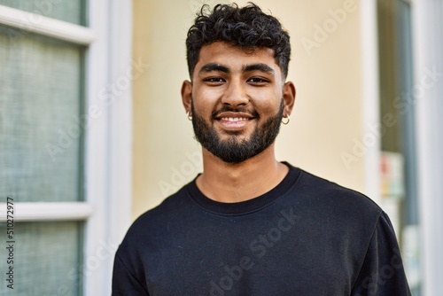 Vászonkép Young arab man smiling confident at street