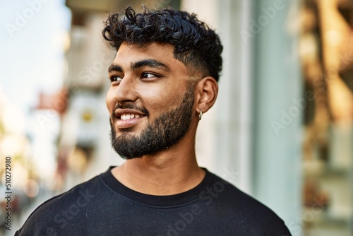 Fotótapéta Young arab man smiling confident at street