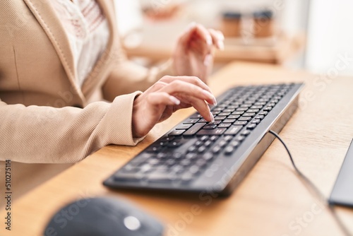 Young blonde woman business worker using keyboard at office