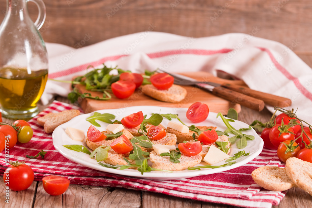 Friselle with cherry tomatoes and arugula. Friselle with cherry tomatoes and arugula.