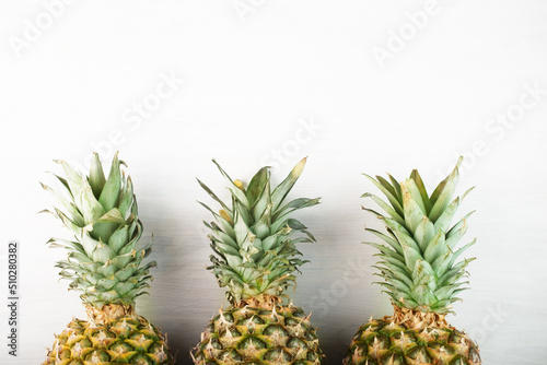 pineapples on a white background, ripe fruits, summer concept