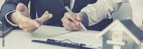 Real estate agent or sales manager has proposed terms and conditions to customers who sign house purchase agreements with insurance, Agreement to sign the purchase contract concept.