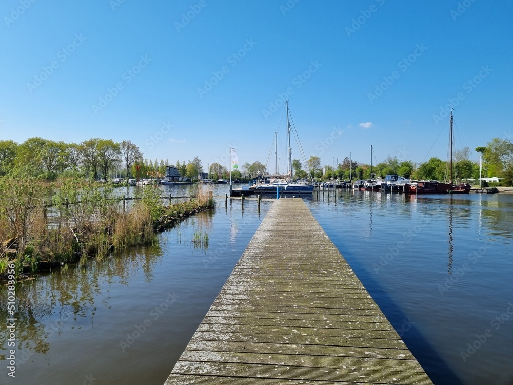 Long jetty and the Marina at (Dutch) Slotermeer (Frisian) Sleatermar (a big lake) near Balk, Friesland, Netherlands, in the background