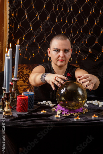 Konstfotografi Bald woman fortune teller reads the future in a crystal ball.