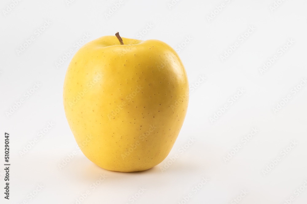 Yellow apple isolated on bright background. Close up view.