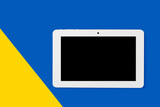 white tablet on the background of the flag of Ukraine
