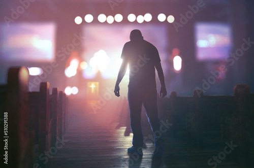 Man walking down aisle in church