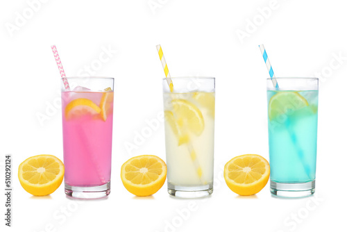 Cold, colorful summer lemonade drinks. Pink, yellow and blue colors in tall glasses with lemons isolated on a white background.