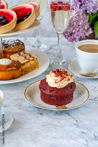 Selection of gourmet cakes with coffee and sparkling wine on a table