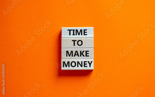 Time to make money symbol. Concept words Time to make money on wooden blocks on a beautiful orange table orange background. Business, finacial and time to make money concept.
